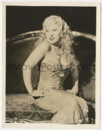 7d812 SHE DONE HIM WRONG 8x10.25 still '33 Mae West sitting on couch in super low-cut dress!