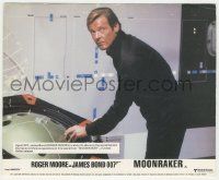 7d070 MOONRAKER color English FOH LC '79 c/u of Roger Moore as James Bond snooping in enemy base!