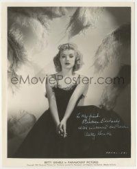 7x0695 BETTY GRABLE signed 8.75x10 still '38 great portrait in low-cut dress surrounded by feathers!