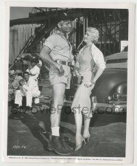 8r291 EAST OF SUMATRA candid 8x10 still '53 Jeff Chandler says his legs are prettier than Maxwell's!