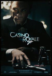 9c165 CASINO ROYALE teaser DS 1sh '06 Craig as James Bond sitting at poker table w/gun!