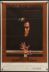 1b417 TIGHTROPE Argentinean '84 Clint Eastwood is a cop on the edge, cool handcuff image!