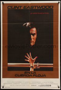 2c363 TIGHTROPE Argentinean '84 Clint Eastwood is a cop on the edge, cool handcuff image!