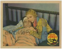 2d163 DAWN TRAIL LC '30 c/u of pretty Miriam Seegar tending to wounded Buck Jones laying in bed!