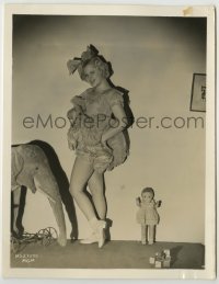 2w642 MARY CARLISLE 8x10.25 still '30s hiking up her skirt, standing by children's toys!