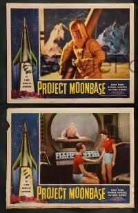 5j817 PROJECT MOONBASE 4 LCs '53 Robert Heinlein, border art of rocket ship + wacky astronauts!