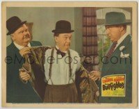 7c140 BULLFIGHTERS LC 1945 Oliver Hardy removes Stan Laurel's coat as Ralph Sanford threatens them!