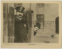 7c237 DOG'S LIFE LC 1918 Charlie Chaplin hiding behind fence sees policeman, safety first!