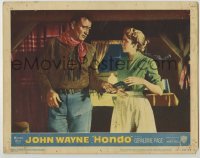 7c389 HONDO 3D LC #1 1953 close up of cowboy John Wayne handing pistol to pretty Geraldine Page!