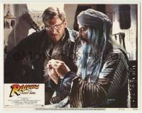 7c658 RAIDERS OF THE LOST ARK int'l LC #7 1981 Tutte Lemkow explains pendant to Harrison Ford!