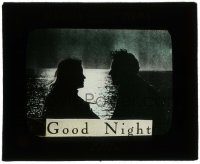 7d329 GOOD NIGHT glass slide 1920s lovers in the moonlight by the ocean to get people to leave!