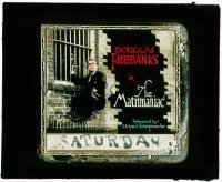 7d378 MATRIMANIAC glass slide 1916 Douglas Fairbanks Sr. hanging from bars on side of building!