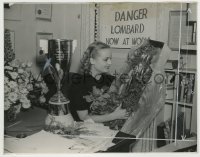 7h283 CAROLE LOMBARD 7.75x10 still 1938 holding joke carrot bouquet with faux danger sign behind!
