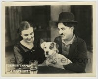 8a236 DOG'S LIFE 8x10 LC 1918 c/u of Charlie Chaplin telling Edna Purviance she will love his dog!