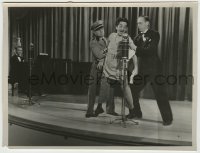 8a628 MILLIONS IN THE AIR deluxe 7.5x10 still 1935 radio emcee & usher drag crazy guy off stage!
