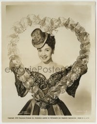 8a690 OLGA SAN JUAN 8x10.25 still 1945 wearing a wild dress & tiny hat posing in a big lace heart!