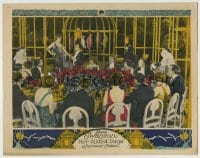 8k655 HER GILDED CAGE LC 1922 lots of people at table watch Gloria Swanson by giant bird cage!