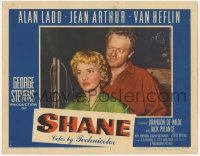 8z807 SHANE LC #7 1953 close portrait of smiling Van Heflin standing behind pretty Jean Arthur!
