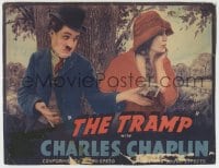 8z033 TRAMP LC R1940 Charlie Chaplin in classic outfit holding out money to uninterested Purviance!
