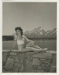 9x009 ANN RUTHERFORD deluxe 10x12.75 still 1940s sitting on rock wall by lake in skimpy swimsuit!