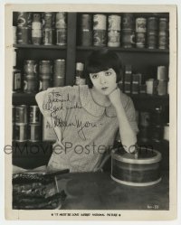 1b382 COLLEEN MOORE signed 8x10 still 1926 looking bored at store counter in It Must Be Love!