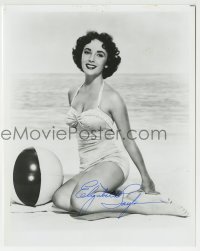 1b841 ELIZABETH TAYLOR signed 8x10 REPRO still 1980s sexy portrait in swimsuit kneeling on beach!
