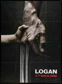 1p734 LOGAN teaser French 1p 2017 super c/u of tiny hand holding Hugh Jackman's Wolverine claw!