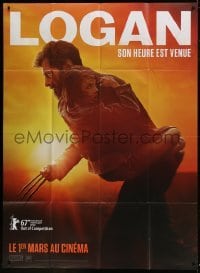 2p879 LOGAN teaser French 1p 2017 Jackman in the title role as Wolverine holding Dafne Keen!