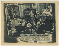3c723 OKLAHOMA KID LC R1943 James Cagney holds guns on Humphrey Bogart & cowboys in saloon!