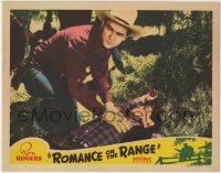 3z823 ROMANCE ON THE RANGE LC 1942 close up of Roy Rogers examining unconscious man on the ground!
