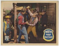 3z982 WINDS OF THE WASTELAND LC 1936 crowd watching big John Wayne fighting with bad guy, rare!