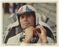 6s338 JAMES GARNER signed color 8x10 still #16 1967 c/u strapping on racing helmet in Grand Prix!