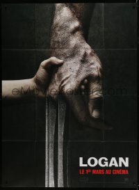 6t885 LOGAN teaser French 1p 2017 super c/u of tiny hand holding Hugh Jackman's Wolverine claw!