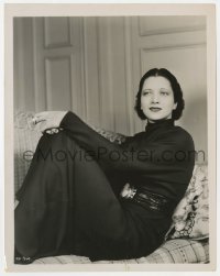 7h532 KAY FRANCIS 8x10.25 still 1930s seated close up in cool gown on couch with cigarette!