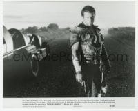 7h594 MAD MAX 2: THE ROAD WARRIOR 7.75x9.5 still 1982 best image of Mel Gibson standing by his car!