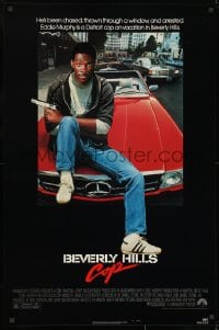 8w107 BEVERLY HILLS COP 1sh 1984 great image of detective Eddie Murphy sitting on red Mercedes!