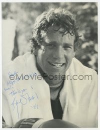 8y947 RYAN O'NEAL signed 7.5x9.75 REPRO still 1984 c/u wearing boxing gloves from The Main Event!