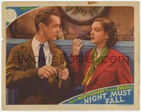 9b621 NIGHT MUST FALL LC 1937 c/u of Rosalind Russell staring at Robert Montgomery carving wood!