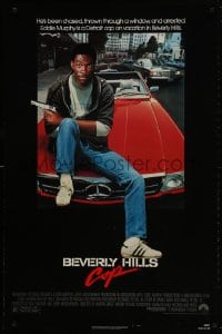 9w555 BEVERLY HILLS COP 1sh 1984 great image of detective Eddie Murphy sitting on red Mercedes!
