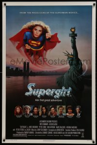 9w917 SUPERGIRL 1sh 1984 super Helen Slater in costume flying over Statue of Liberty!