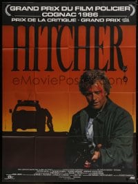 1j717 HITCHER French 1p 1986 different image of bloodied Rutger Hauer with machine gun!