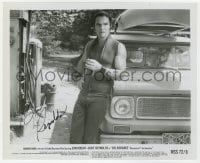 3d458 BURT REYNOLDS signed 8.25x10 still 1972 great close up trying to hire drivers in Deliverance!