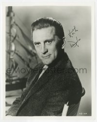 3d573 KIRK DOUGLAS signed 8x10.25 still 1960s great seated portrait with ship in background!