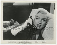 3h010 HOW TO MARRY A MILLIONAIRE 8x10.25 still 1953 puzzled Marilyn Monroe talking on phone!