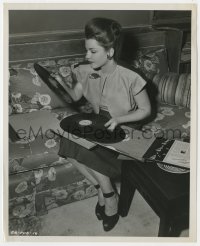 4d139 ANNE BAXTER  8x10 still 1946 choosing a record from her vast collection, Angel On My Shoulder!