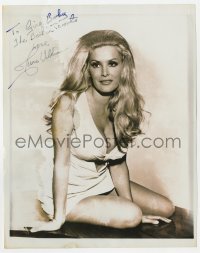4x827 JUNE WILKINSON signed 8x10 REPRO still 1970s on table in skimpy outfit showing cleavage!