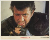 5w587 MAD MAX 2: THE ROAD WARRIOR int'l LC 1982 super close up of Mel Gibson loading his gun!