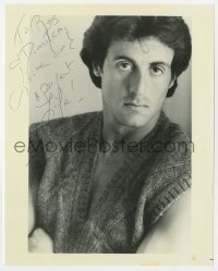 6b978 SYLVESTER STALLONE signed 8x10 REPRO still 1980s c/u wearing nothing under a sweater vest!