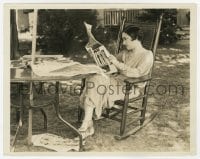 6h382 GLORIA SWANSON 8x10 still 1924 reading newspaper at her new home in rocking chair by Hommel!