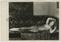 7f258 CLARA BOW 8x11 key book still 1920s spread out on a couch in wonderful dress & vamp pose!